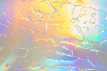 Blurred defocused abstract iridescent foil wallpaper texture. Holographic soft pastel colors...