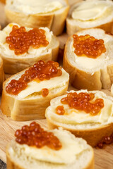 Thinly sliced baguette with salmon caviar and butter
