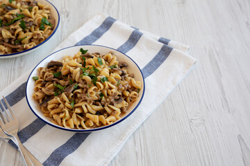 Homemade One Skillet Ground Beef Stroganoff with Mushrooms and Noodles on a Plate, side view. Copy space.