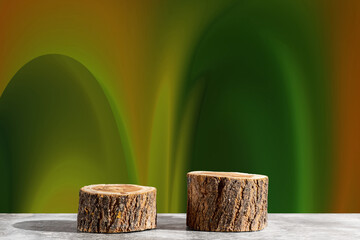Two wooden round saw cuts on a fantasy green-orange background. Natural podiums for advertising...