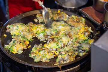 Cooking Taiwan famous Oyster omelette in local food store