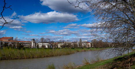 Obraz premium White clouds over rooftops. panorama. beautiful sky.