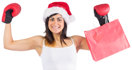 Festive brunette in boxing gloves holding shopping bags