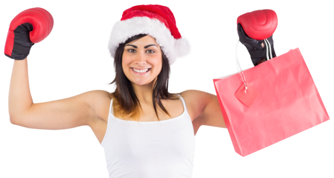 Festive brunette in boxing gloves holding shopping bags