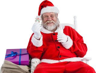 Portrait of Santa Claus holding milk and cookie