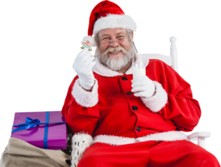 Portrait of Santa Claus holding milk and cookie
