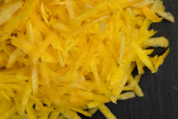 Finely grated yellow carrots in the kitchen