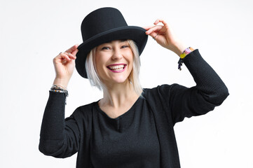 Smiling blonde woman in black hat isolated on white background. Young woman with beautiful smile happy and excited.