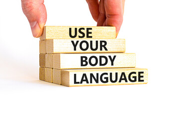 Use your body language symbol. Concept words Use your body language on wooden block. Beautiful white table white background. Motivational business use your body language concept. Copy space.