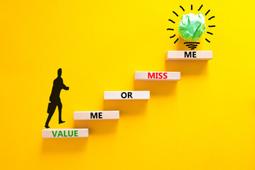 Value or miss me symbol. Concept words Value me or miss me on wooden block. Beautiful yellow table yellow background. Businessman icon. Business psychological and value or miss me concept. Copy space.