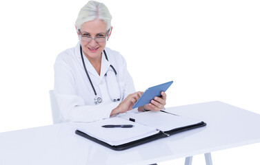 Portrait of smiling female doctor using digital tablet at desk