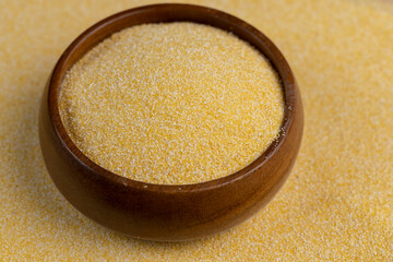 Round wooden bowl with dry corn flour