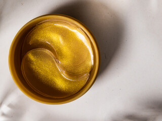Gold moisturizing eye patches in a package.Top view.