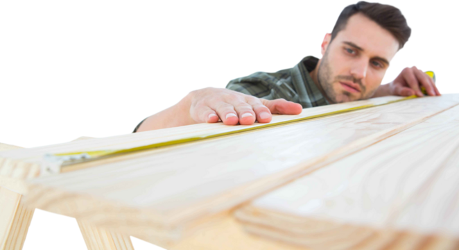 Worker measuring wooden plank 