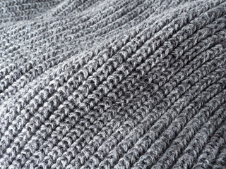 Gray structure of knitted woolen fabric close-up