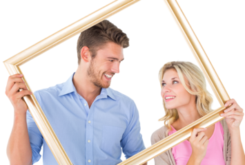 Attractive young couple holding picture frame
