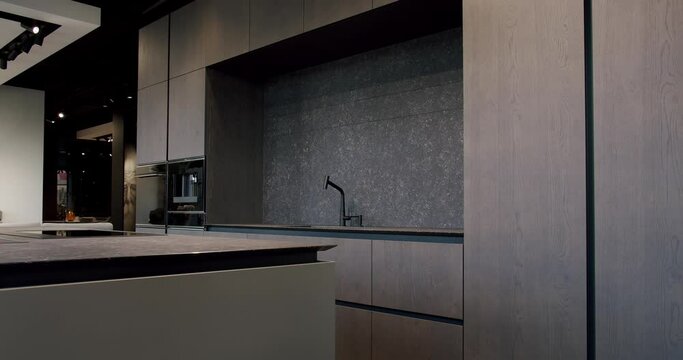 Real Estate. Luxury kitchen with an island. Modern interior in luxury house. Modern Chrome Faucet. Modern and spacious wooden kitchen room. Minimalist design in New Home. Real Luxury Design Interior.