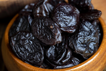 Black pile of prunes from a large number of ripe plums