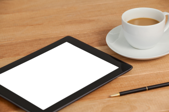 Digital tablet with pen and cup of tea