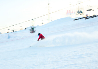 Fototapeta na wymiar Child teenager boy skiing fast in mountains