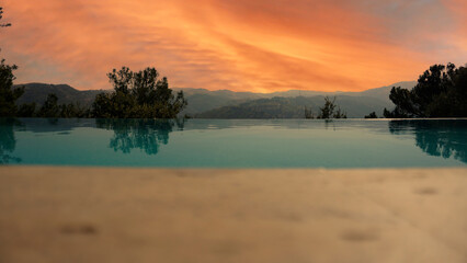 Fototapeta na wymiar Pool view on sunset nature background.