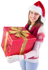 Young woman holding a gift while smiling at camera 