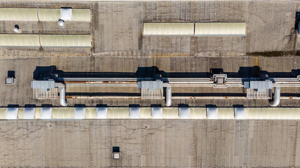 Drop down view of HVAC system with cooling pipes running along the roof.