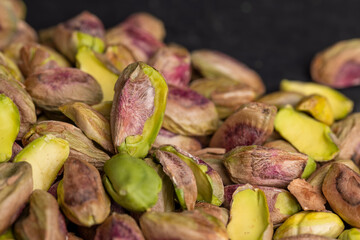 Crispy delicious pistachios with salt on the table