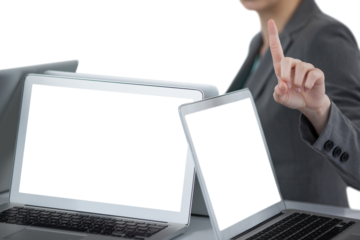 Businesswoman showing finger while standing by laptop computer