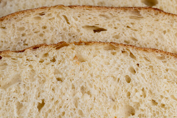 A cut loaf of round-shaped wheat bread