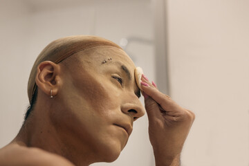 Drag queen applying make-up
