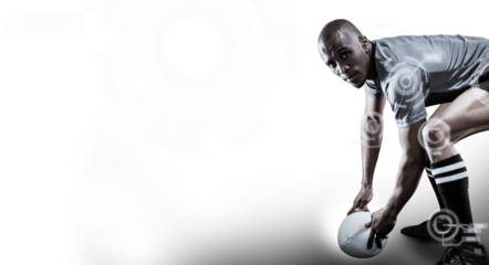 Rugby player holding ball while bending