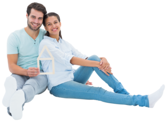 Cute couple sitting holding a house shape