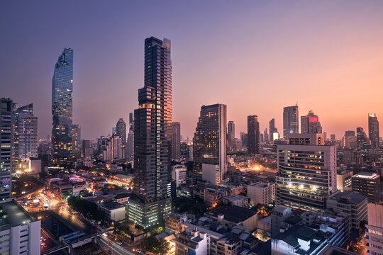 Night view of urban skyline at dusk. Downtown with skyscrapers and modern architecture. Bangkok, Thailand...
