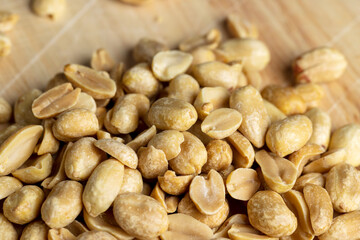 Roasted peanuts on a wooden cutting board