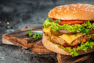 Homemade hamburger with beef, tomato, cheese, and lettuce