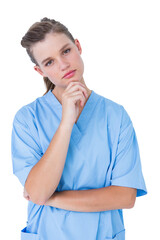 Thoughtful nurse looking at camera with hand on chin 