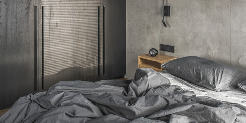 Minimalistic black wall light in modern bedroom interior in grey and black colours, concrete wall design, clay wall. Contemporary interior design aesthetics with concrete details