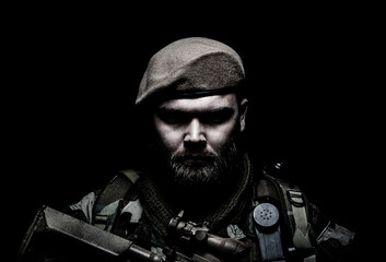 Fototapeta premium Close up portrait of bearded commando fighter, army special forces soldier, private military company mercenary wearing beret. Pride and tradition of military service, elite or special forces unit