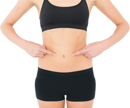 Closeup mid section of a fit woman with hands on stomach