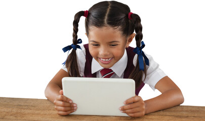 Schoolgirl using digital tablet at desk