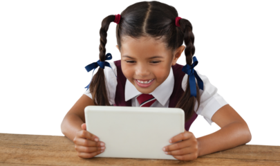 Schoolgirl using digital tablet at desk