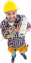 Frustrated handyman holding various tools