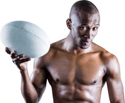 Portrait of confident shirtless sportsman holding rugby ball