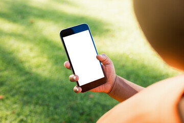 Cropped image of boy holding smart phone
