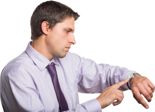Young businessman looking at wristwatch
