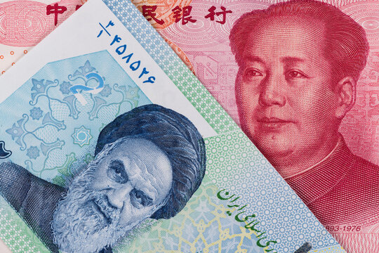 Fragments of banknotes of 100 Chinese yuan and 2/2000 Iranian tuman/reals with portraits of Chairman Moa and Ruhollah Khomeini