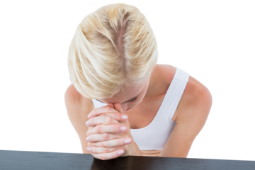 Woman praying by table