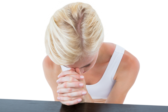 Woman praying by table
