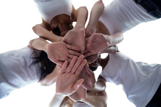 Women in a circle putting their hands together
